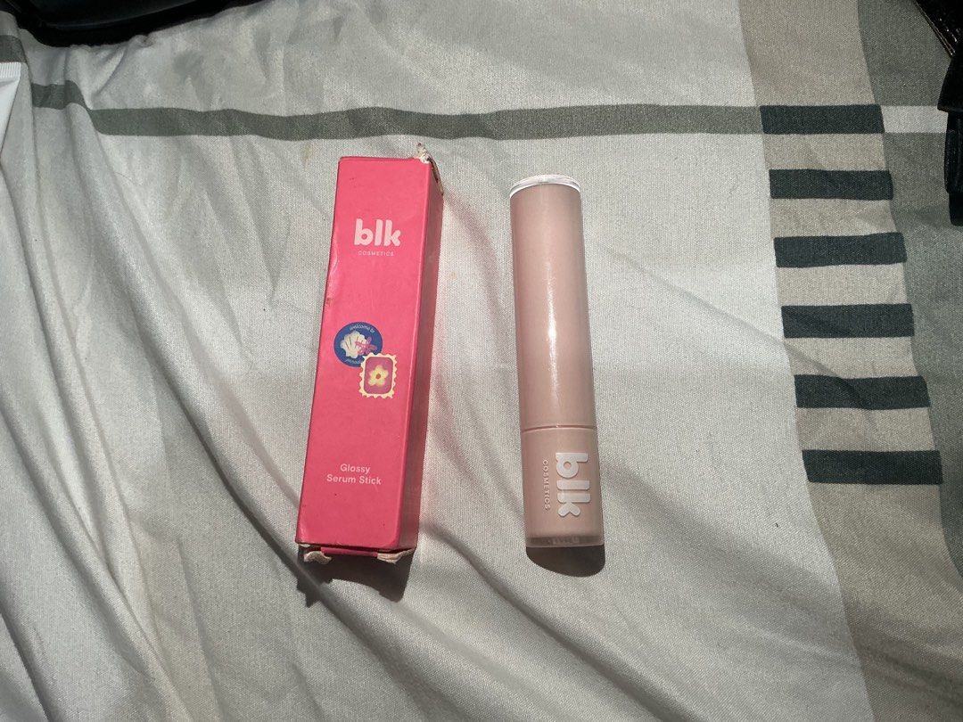 BLK cosmetics Glossy Serum Stick (Category: Makeup) located in Quezon City. Submitted by daenerys44 (Listing ID 1466292093, Image 1). Description: Glossy Serum Stick - Shade: Cove - Shiny and hydrating - Swatched once / lightly used. Realized color not my liking. Just stored. Bought just this July 2026. - Packaging: Twist-up tube with original pink outer box. Manufactured 2026 on box - Perfect for: Quick, everyday glossy makeup looks.