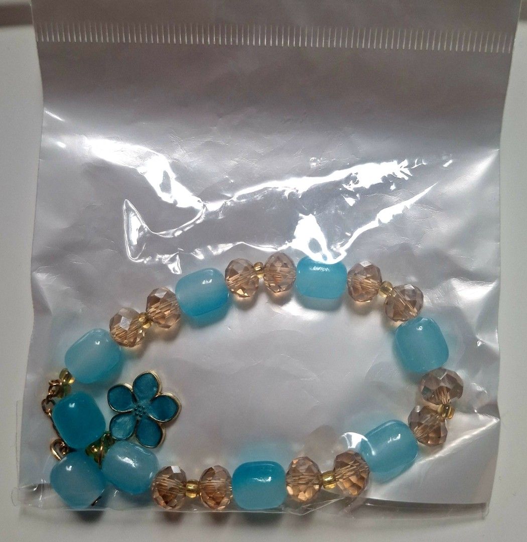 Blue bead bracelet with flower charm (Category: Bracelets) located in Taguig. Submitted by fits.for.less (Listing ID 1466165771, Image 1). Description: 60 pesos MOP: Gcash MOD: lalamove/grab, pick-up if malapit lang.