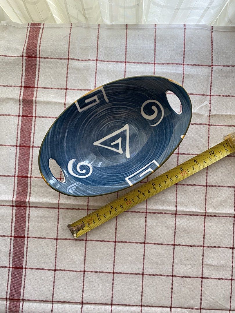 Blue Ceramic Oval Bowl with Handles and Geometric Pattern (Category: Dinnerware & Cutlery) located in Mandaluyong City. Submitted by lovegood711 (Listing ID 1466159687, Image 3). Description: An elegant bowl to display your fruits or pastries, especially for special occasions. - Material: Ceramic - Design: Blue and white with geometric and swirl motifs - Size: Approximately 24 cm across - Features: Two handle cutouts on opposite ends, white exter