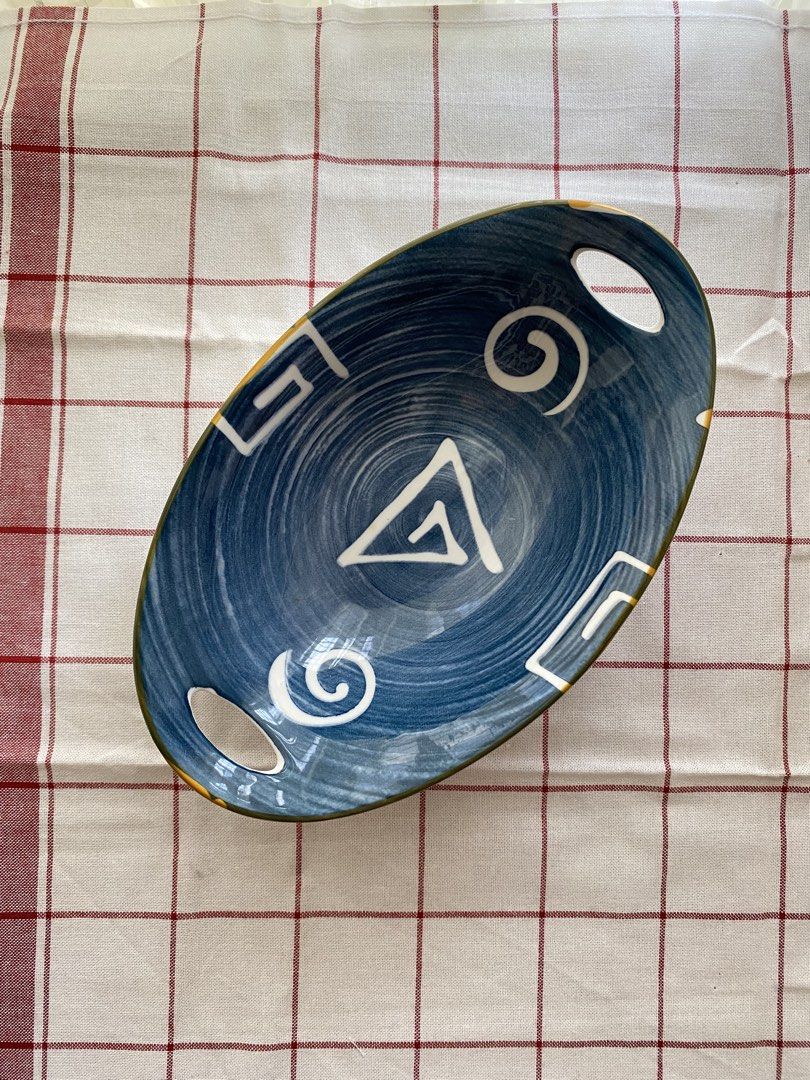 Blue Ceramic Oval Bowl with Handles and Geometric Pattern (Category: Dinnerware & Cutlery) located in Mandaluyong City. Submitted by lovegood711 (Listing ID 1466159687, Image 1). Description: An elegant bowl to display your fruits or pastries, especially for special occasions. - Material: Ceramic - Design: Blue and white with geometric and swirl motifs - Size: Approximately 24 cm across - Features: Two handle cutouts on opposite ends, white exter