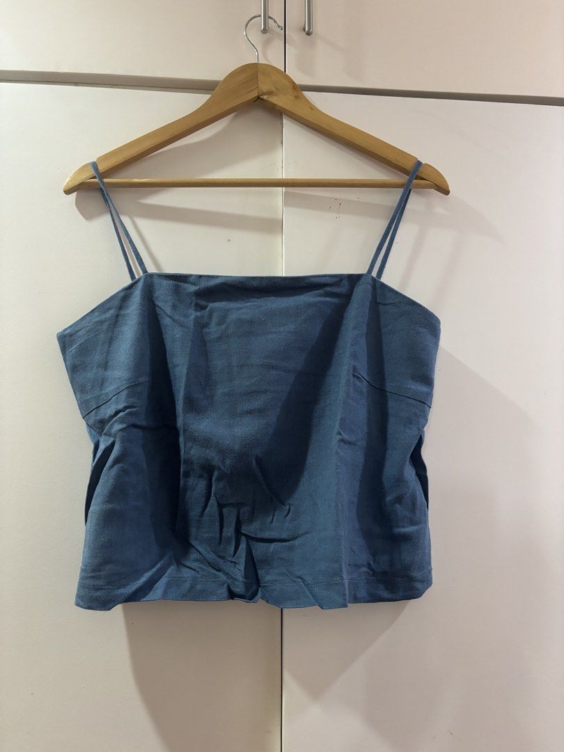 Blue Square Neck Camisole Tank Top (Category: Sleeveless) located in Las Pinas. Submitted by misg0905 (Listing ID 1466203517, Image 1). Description: - Color: Blue - Style: Casual camisole top with a straight square neckline - Straps: Trendy thin double straps - Material: Textured, lightweight fabric ideal for warm weather - Fit: Relaxed fit through the body - Versatility: Easy to pair with high-waisted jeans, skirts, or shorts - Condition: Brand 