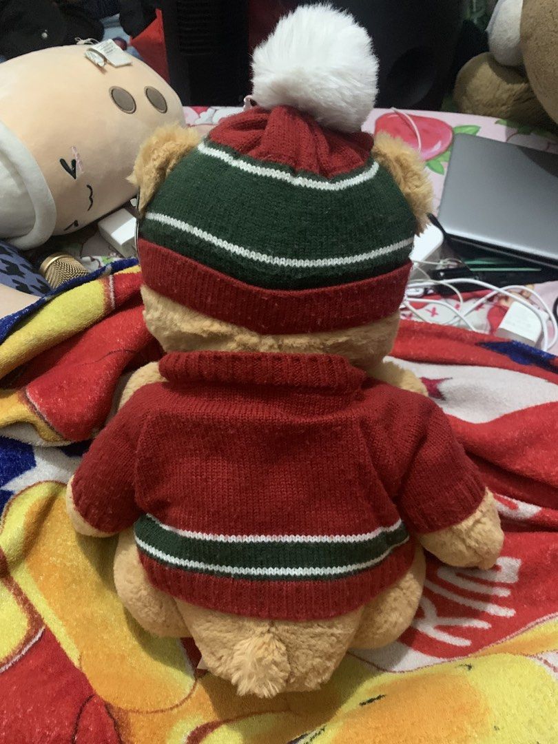BNWT Harrods 2023 Christmas Ethan Bear Plush (Category: Plushies & Soft Toys) located in Las Pinas. Submitted by aokisells (Listing ID 1466328950, Image 2). Description: - Official 2023 Harrods collectible bear - Wears a festive red and green knit sweater and matching winter beanie with a fluffy white pom-pom - Features embroidered 'Harrods 2023' detail on the right foot paw - Made with ultra-soft plush fur material - Clean original tag attached 