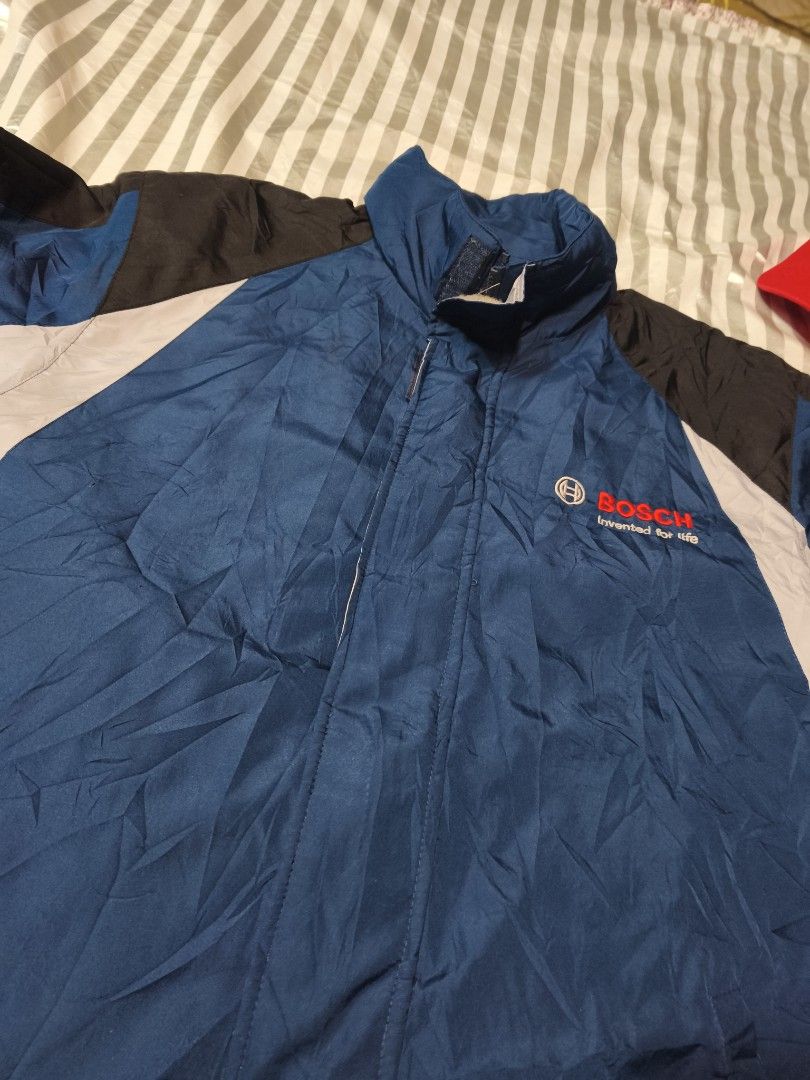 Bosch Corporate Windbreaker Jacket Blue Black (Category: Coats, Jackets and Outerwear) located in Baguio. Submitted by boneteezandharmony (Listing ID 1466330512, Image 3). Description: - Official Bosch windbreaker jacket - Blue body with stylish black and light grey color block panels - Embroidered 'Bosch Invented for life' logo on the left chest - Stand-up collar, full zip closure, and adjustable cuffs - Pit-to-pit: approx. 27 inches - Length: a