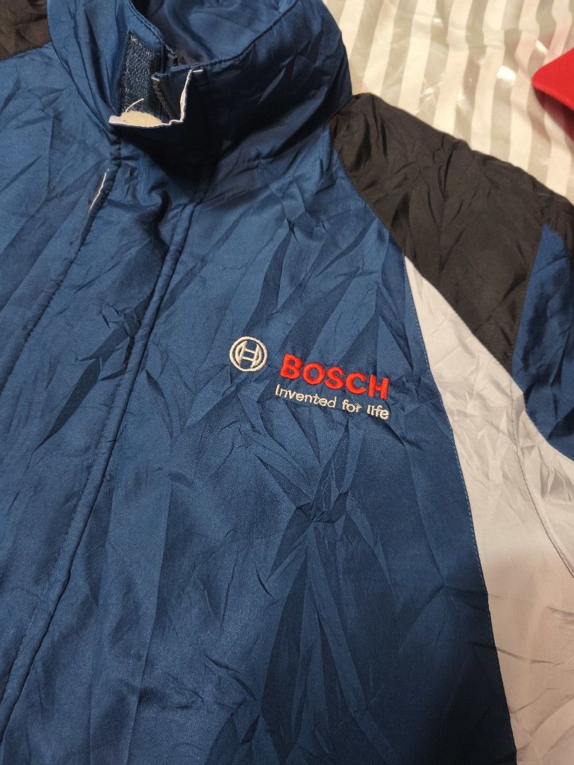Bosch Corporate Windbreaker Jacket Blue Black (Category: Coats, Jackets and Outerwear) located in Baguio. Submitted by boneteezandharmony (Listing ID 1466330512, Image 2). Description: - Official Bosch windbreaker jacket - Blue body with stylish black and light grey color block panels - Embroidered 'Bosch Invented for life' logo on the left chest - Stand-up collar, full zip closure, and adjustable cuffs - Pit-to-pit: approx. 27 inches - Length: a