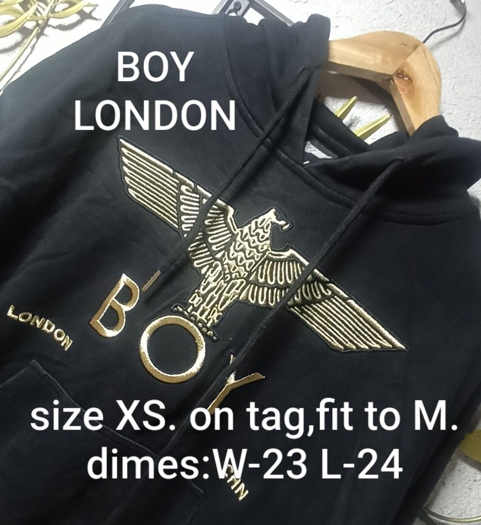 Boy London Hoodie (Category: Coats, Jackets and Outerwear) located in Kawit. Submitted by deidzdzn (Listing ID 1466216809, Image 1). Description: - Brand: Boy London - Color: Black with striking gold graphic embroidery on chest and sleeves - Size: Tagged XS, but fits like a comfortable Medium - Dimensions: Width 23" x Length 24" - Features: Front kangaroo pocket, drawstring hood - Material: Heavyweight, premium quality fabric.