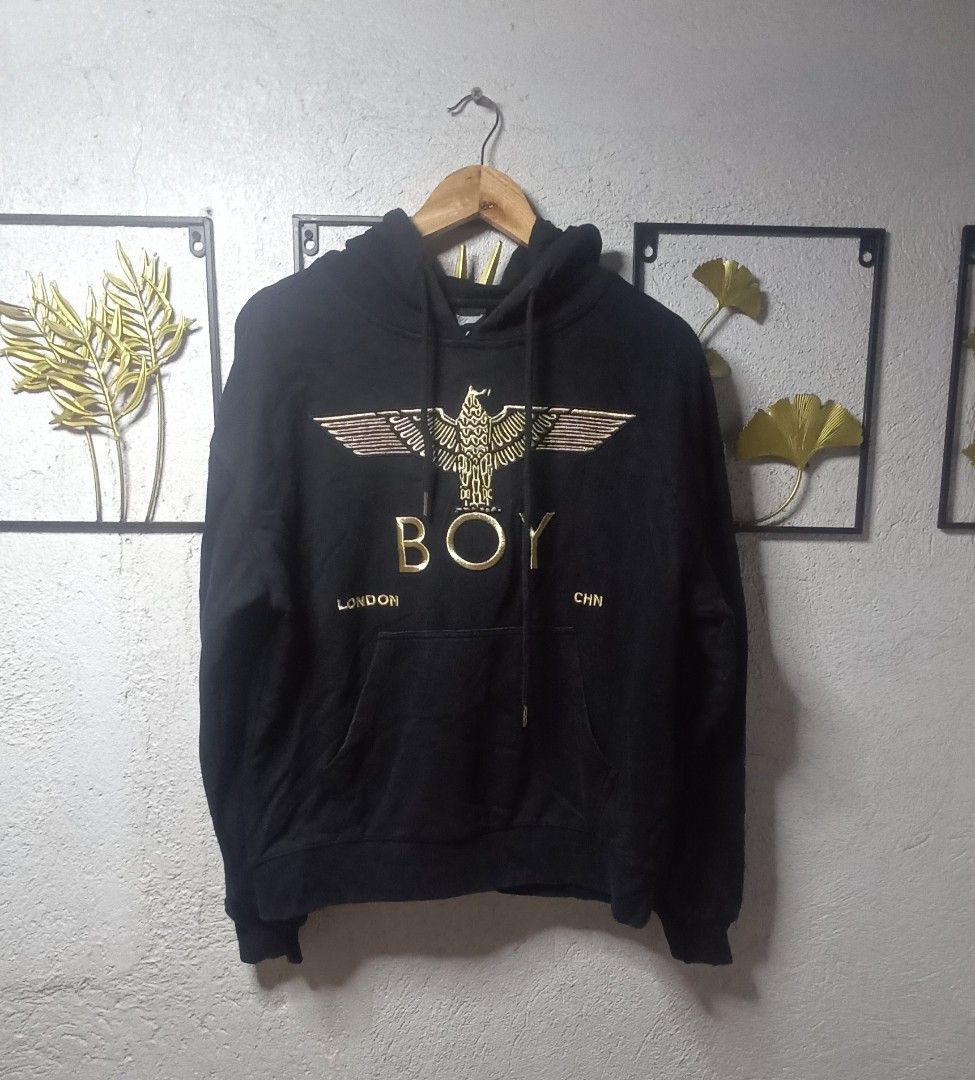 Boy London Hoodie (Category: Coats, Jackets and Outerwear) located in Kawit. Submitted by deidzdzn (Listing ID 1466216809, Image 3). Description: - Brand: Boy London - Color: Black with striking gold graphic embroidery on chest and sleeves - Size: Tagged XS, but fits like a comfortable Medium - Dimensions: Width 23" x Length 24" - Features: Front kangaroo pocket, drawstring hood - Material: Heavyweight, premium quality fabric.