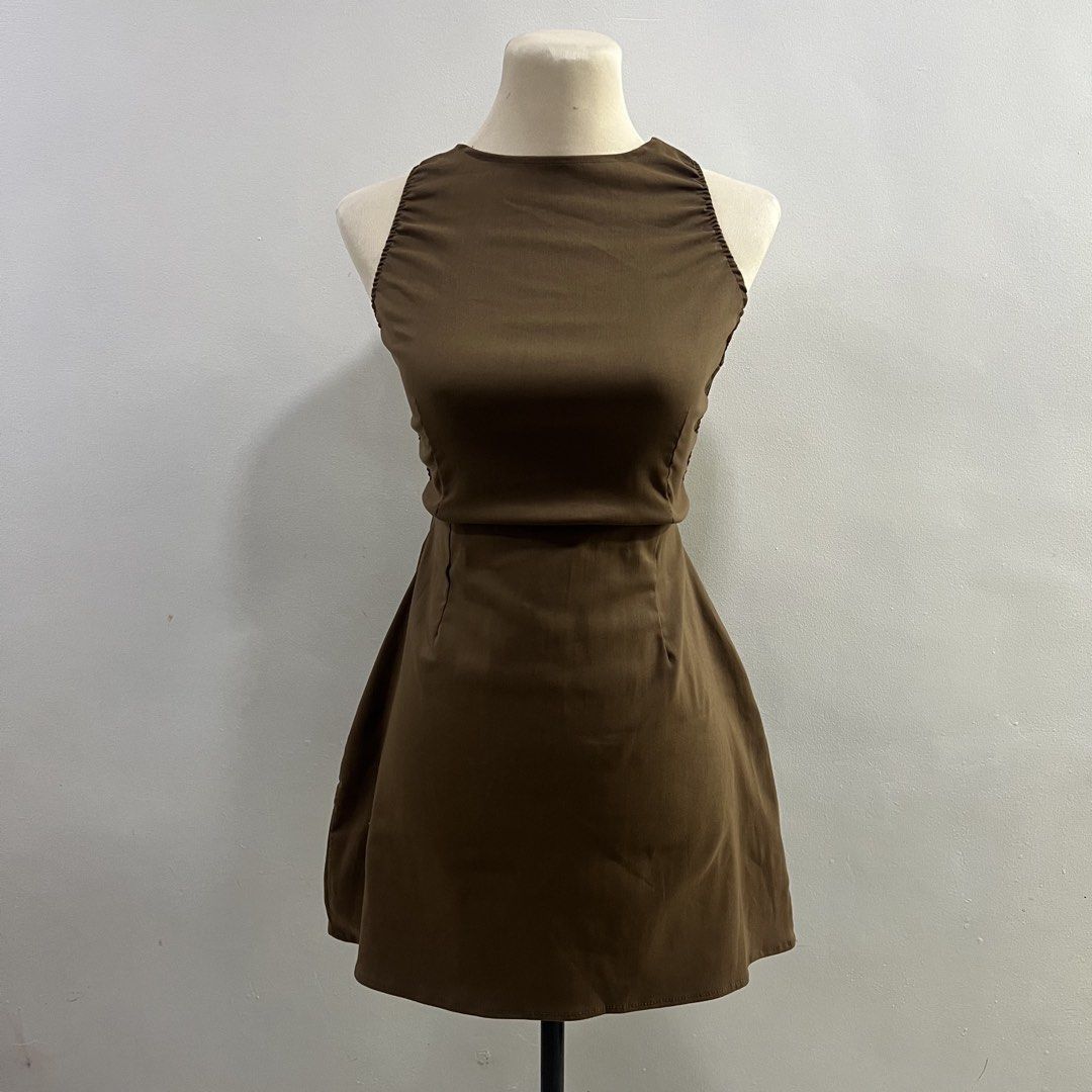 brown backless mock neck mini dress (Category: Dresses) located in Malabon City. Submitted by minidressmonster (Listing ID 1466223599, Image 1). Description: brown cross back mock neck a line mini dress stretchy and very flattering garterized at the back best fit xs-s see last pic for slight flaw.