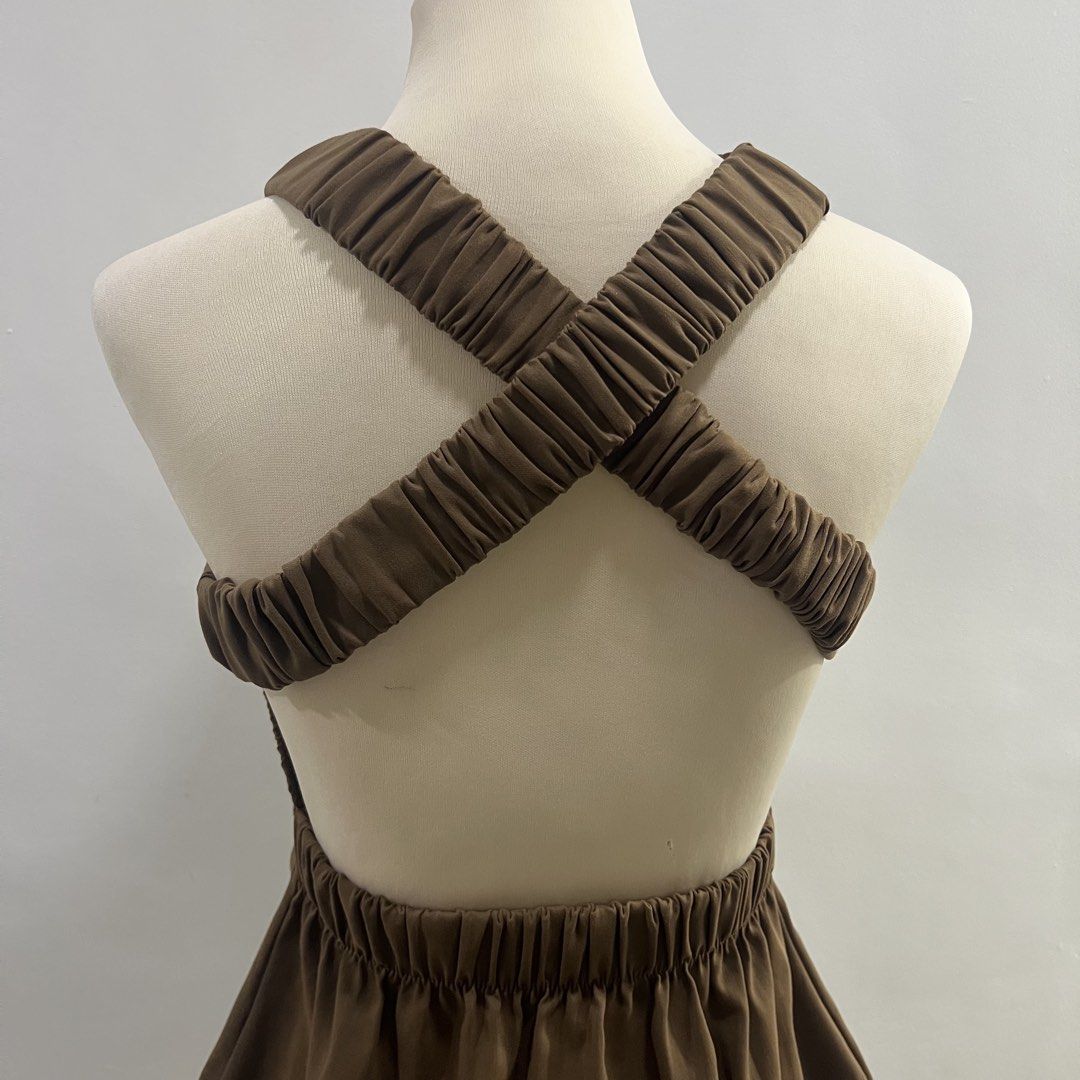 brown backless mock neck mini dress (Category: Dresses) located in Malabon City. Submitted by minidressmonster (Listing ID 1466223599, Image 3). Description: brown cross back mock neck a line mini dress stretchy and very flattering garterized at the back best fit xs-s see last pic for slight flaw.