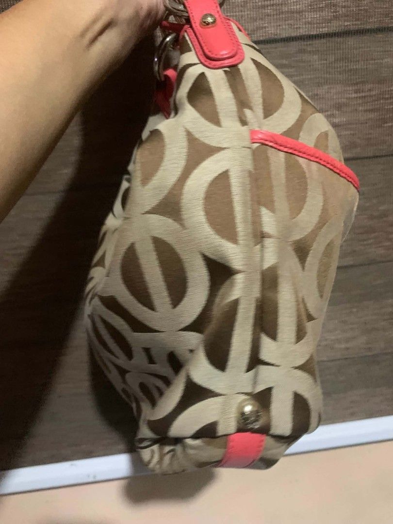 Brown Monogram Pattern Shoulder Bag with Pink Straps (Category: Shoulder Bags) located in Aliaga. Submitted by akishaoshop2010. (Listing ID 1466203795, Image 3). Description: - Authentic monogram fabric body in classic brown and beige - Eye-catching bright pink leather strap and trim accents - Premium gold-tone hardware with stylish ring attachments and base corner studs - Spacious, slouchy interior designed for everyday essentials - Convenient s