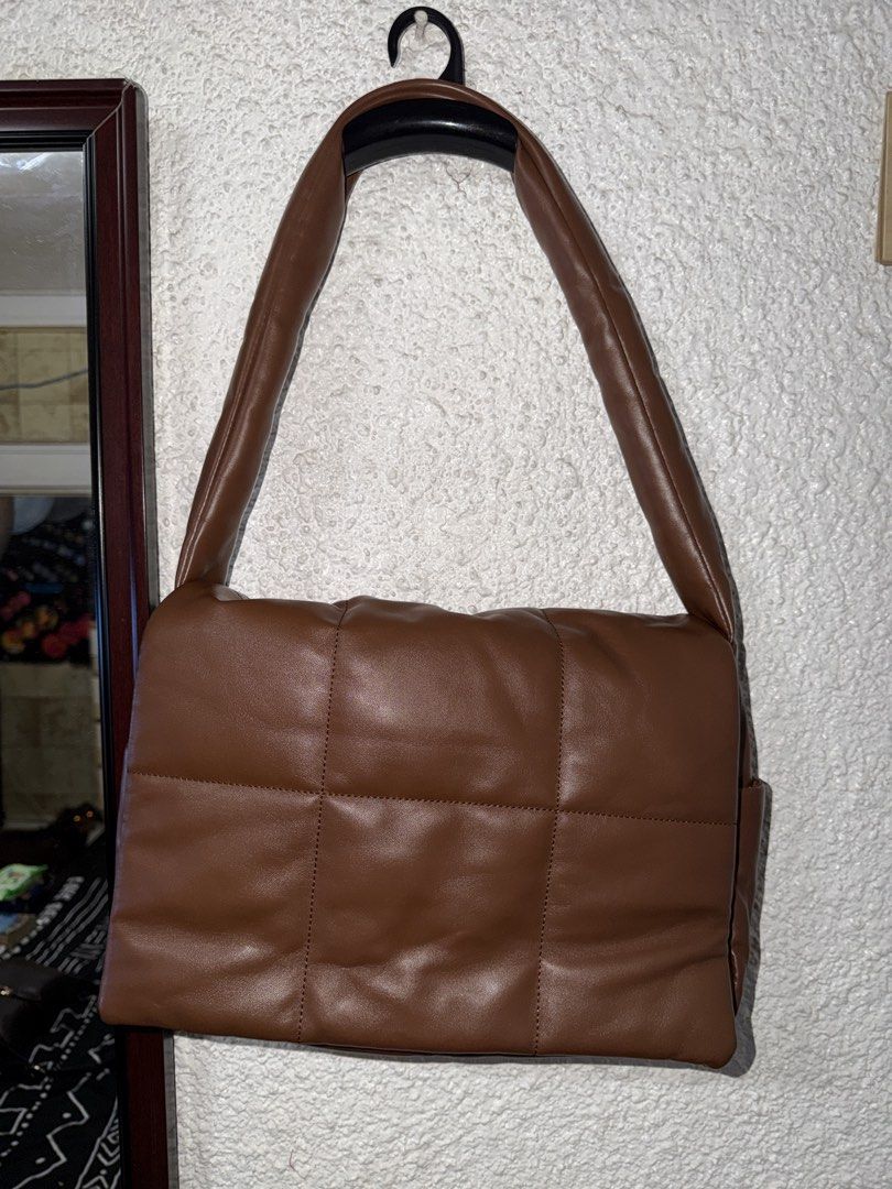 Brown Puffer Quilted Shoulder Bag (Category: Shoulder Bags) located in Angeles City. Submitted by irishholm (Listing ID 1466215830, Image 1). Description: - Used once. In Excellent condition - Brown faux leather shoulder bag - Trendy puffy, quilted grid pattern - Secure magnetic snap front flap closure - Comfortable wide strap for easy shoulder wear - Clean interior with a main compartment and extra organization pockets.