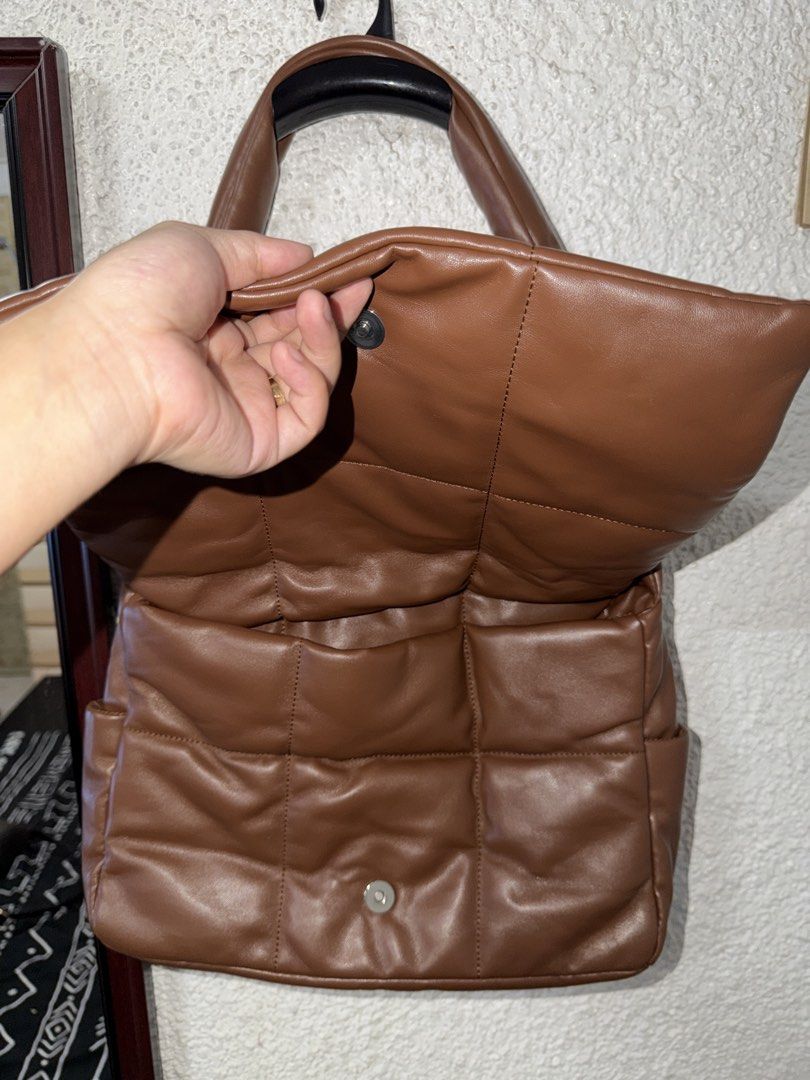 Brown Puffer Quilted Shoulder Bag (Category: Shoulder Bags) located in Angeles City. Submitted by irishholm (Listing ID 1466215830, Image 2). Description: - Used once. In Excellent condition - Brown faux leather shoulder bag - Trendy puffy, quilted grid pattern - Secure magnetic snap front flap closure - Comfortable wide strap for easy shoulder wear - Clean interior with a main compartment and extra organization pockets.