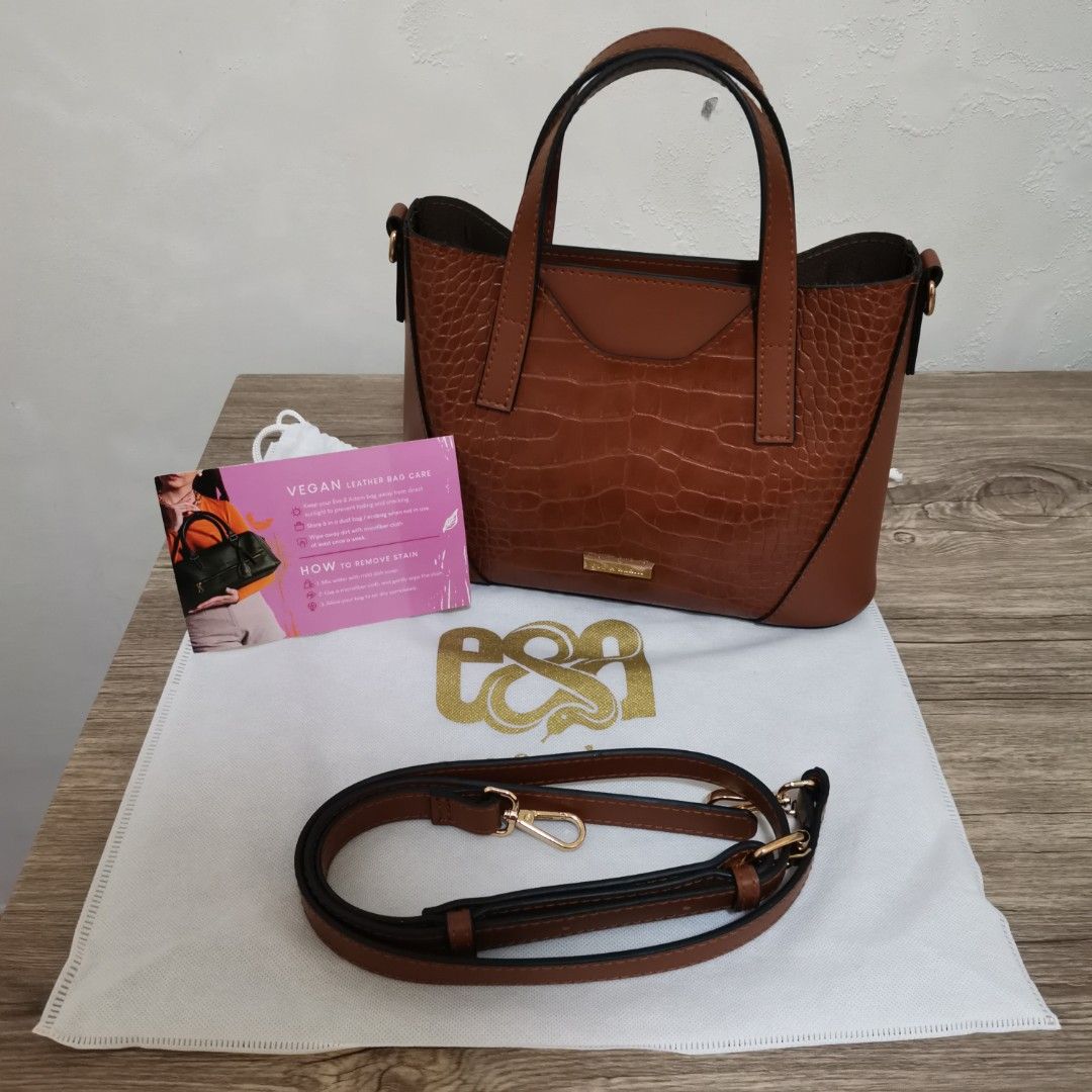 Brown Sling Bag Handbag (Category: Shoulder Bags) located in Bacoor. Submitted by bloomingpetals (Listing ID 1466198194, Image 1). Description: ₱550 FIXED Pre-loved brown handbag/sling bag in good overall condition. Can be carried as a handbag or worn as a sling bag. Purchased for ₱1,100. Details: •Brand: Eve & Adam •Style: Naomi 2-Tone •Color: Brown •Material: Vegan leather •Dimensions: 28 × 9 × 20 cm / 11 × 3.5 × 8 in •Adjustable sling strap in