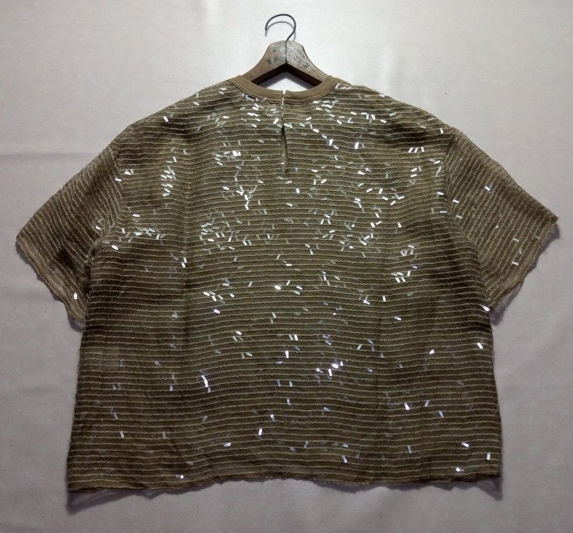 Brunello Cucinelli Sequin Embellished Short Sleeve Blouse Authentic (Category: Blouses) located in Urdaneta. Submitted by josephragontonjr95 (Listing ID 1466308007, Image 2). Description: - Brunello Cucinelli Sequin Embilleshed Short Sleeve Blouse Authentic - SIZE: MEDIUM - DIMENSIONS ⬇️ ⬇️ ⬇️ - WIDTH: 22 - LENGTH: 23 - COLOR RATE: 10/10 - ISSUES/FLAWS: NONE - CONDITION: AS NEW - Color: Taupe - Details: Covered in tiny shimmering sequins over hor
