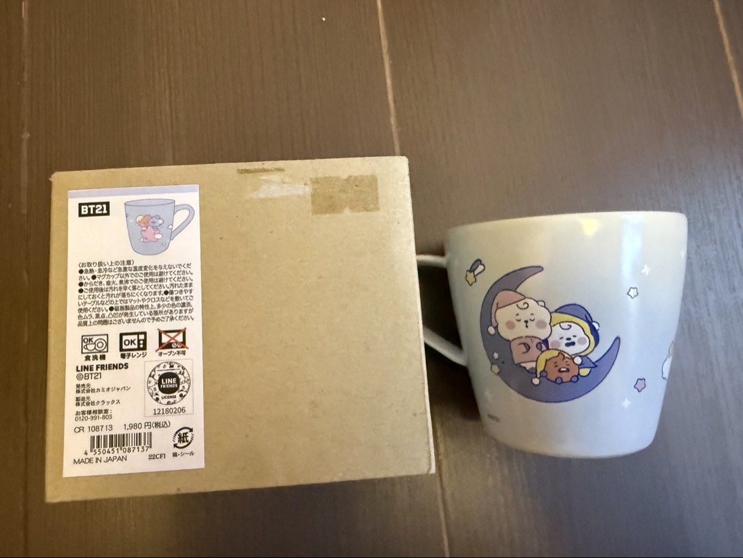 BT21 LINE FRIENDS Ceramic Mug with Original Box (Category: K-Wave Merchandise) located in Marikina City. Submitted by culose (Listing ID 1466156435, Image 2). Description: - Official BT21 merchandise from LINE FRIENDS, made in Japan - Features cute graphics of OT7 on clouds and the moon - Color: Light blue - Microwave and dishwasher safe (do not use in oven) - Includes original brown cardboard box with Japanese text and barcode labels.