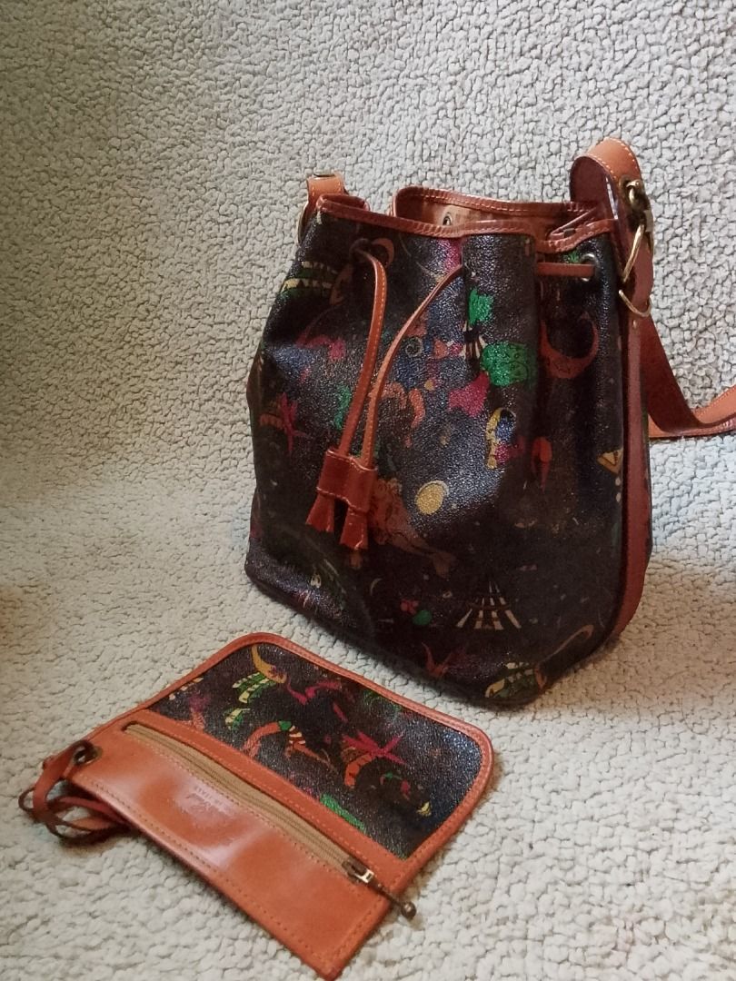 Bucket Shoulder Bag With Multi-Color Pattern And Pouch (Category: Shoulder Bags) located in Las Pinas. Submitted by flyhigh23 (Listing ID 1466269720, Image 1). Description: - Eye-catching multi-color graphic print on a dark textured body - Premium brown leather trim and adjustable shoulder strap with gold-tone hardware - Secure top drawstring closure - Roomy interior designed to fit your daily essentials - Bonus matching small zip pouch with a wr
