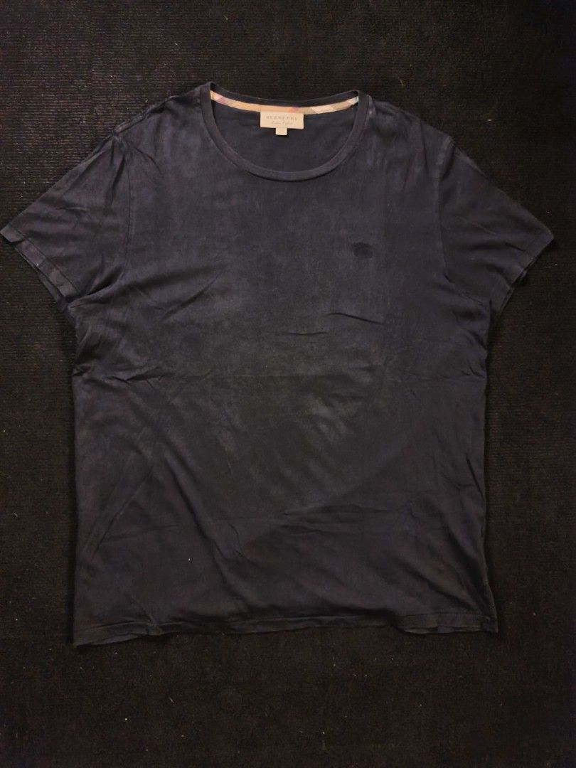 Burberry Black Logo (Category: Tshirts & Polo Shirts ) located in San Fernando. Submitted by gaboo_asncn (Listing ID 1466326677, Image 2). Description: - Burberry Black Logo - Size: XXL on tag (W25/L31) - Condition: Good - Color Rate: 8.5/10 - No Issue Take note: The shirt is black, and since the carpet/background is also black, the color may look slightly faded or less vibrant in the photos. In actual lighting, the shirt has a normal black color