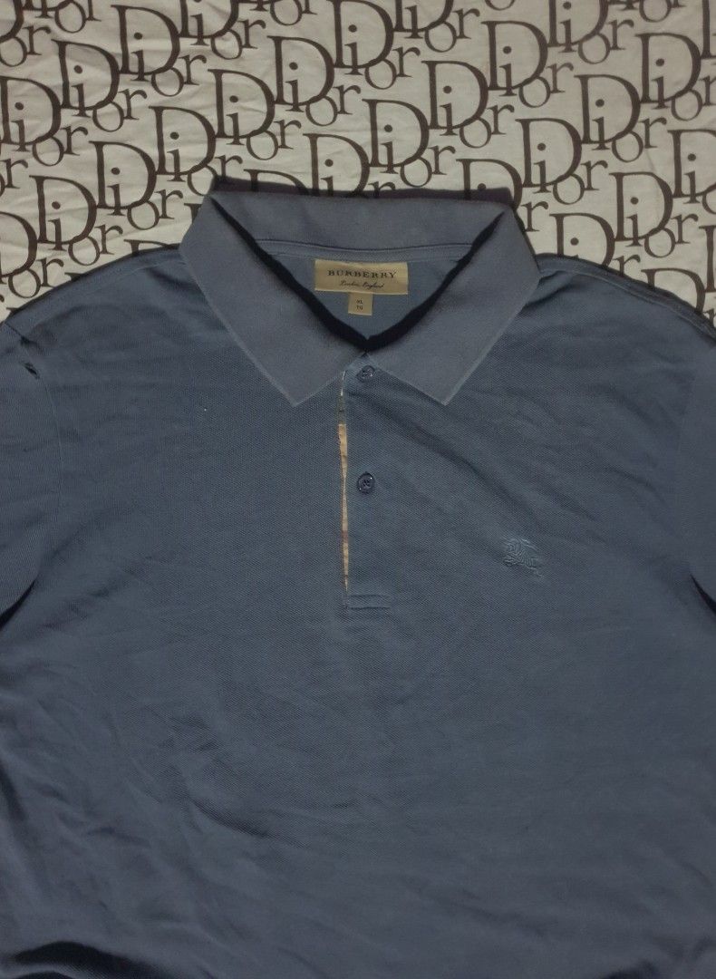 Burberry blue poloshirt (Category: Tshirts & Polo Shirts ) located in San Fernando. Submitted by retro.district. (Listing ID 1466256161, Image 3). Description: - Burberry blue poloshirt - Size: XL ( 23x28) - Condition: Excellent - No issue - Color Rate: 9.5/10 - Need wash.