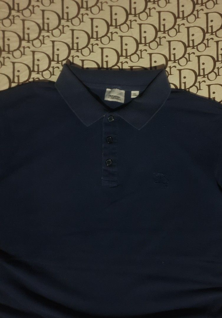 Burberry blue poloshirt (Category: Tshirts & Polo Shirts ) located in San Fernando. Submitted by retro.district. (Listing ID 1466256997, Image 2). Description: - Burberry blue poloshirt - Size: XL 25x29 - Condition: Excellent - No issue - Color Rate: 9.5/10.