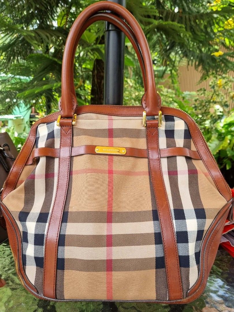 Burberry Brown leather camel check Large (Category: Luxury Bags & Wallets) located in Lucena. Submitted by amirahsoonlineshop (Listing ID 1466175370, Image 2). Description: - Authentic Burberry check canvas tote bag - Features classic tan leather trim and dual top handles - Elegant gold-tone hardware with embossed Burberry metal bar - Secure zip-top closure with dark fabric lining and interior leather tag - Made in Italy - Condition: Normal wear 