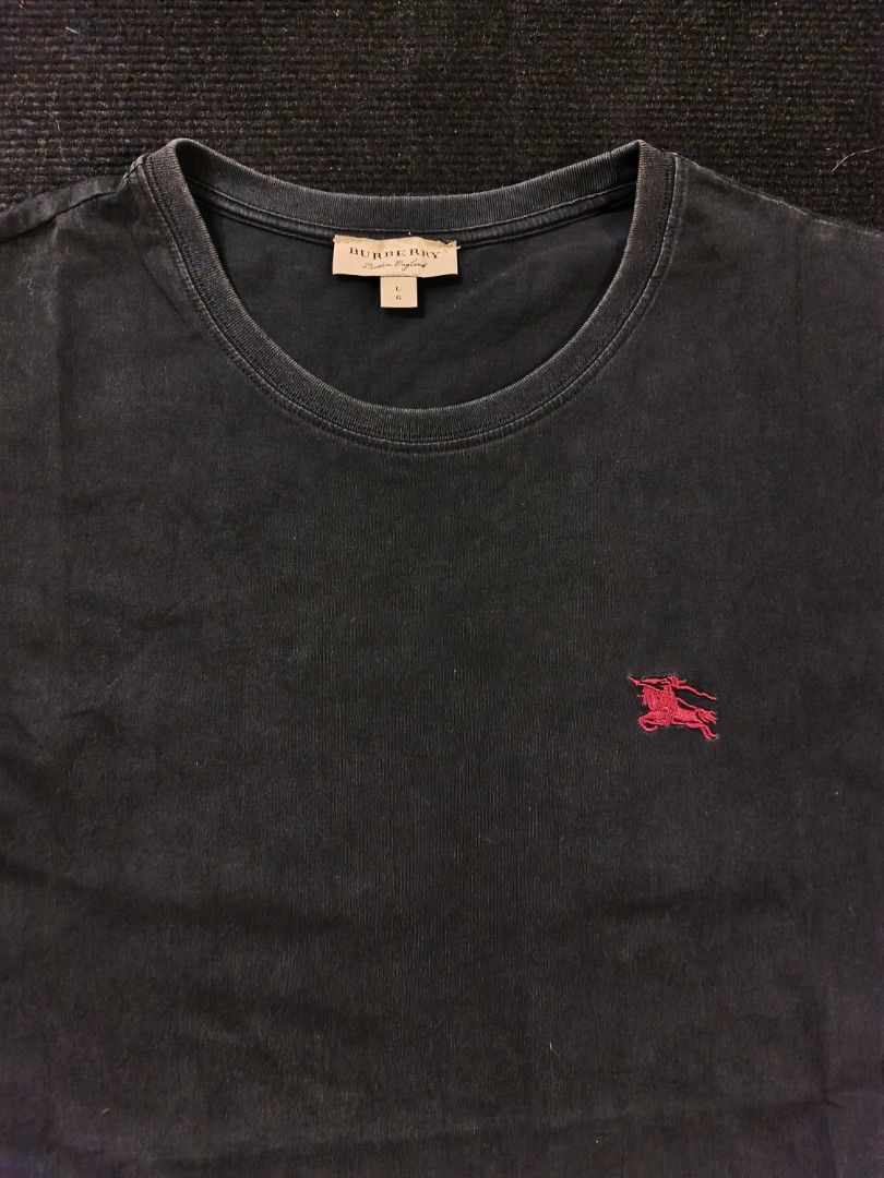 Burberry Red logo (Category: Tshirts & Polo Shirts ) located in San Fernando. Submitted by gaboo_asncn (Listing ID 1466325356, Image 3). Description: - Burberry Red logo - Size: Large on tag (W21/L28) - Condition: Excellent - Color Rate: 9/10 - No Issue Take note: The shirt is black, and since the carpet/background is also black, the color may look slightly faded or less vibrant in the photos. In actual lighting, the shirt has a normal black colo