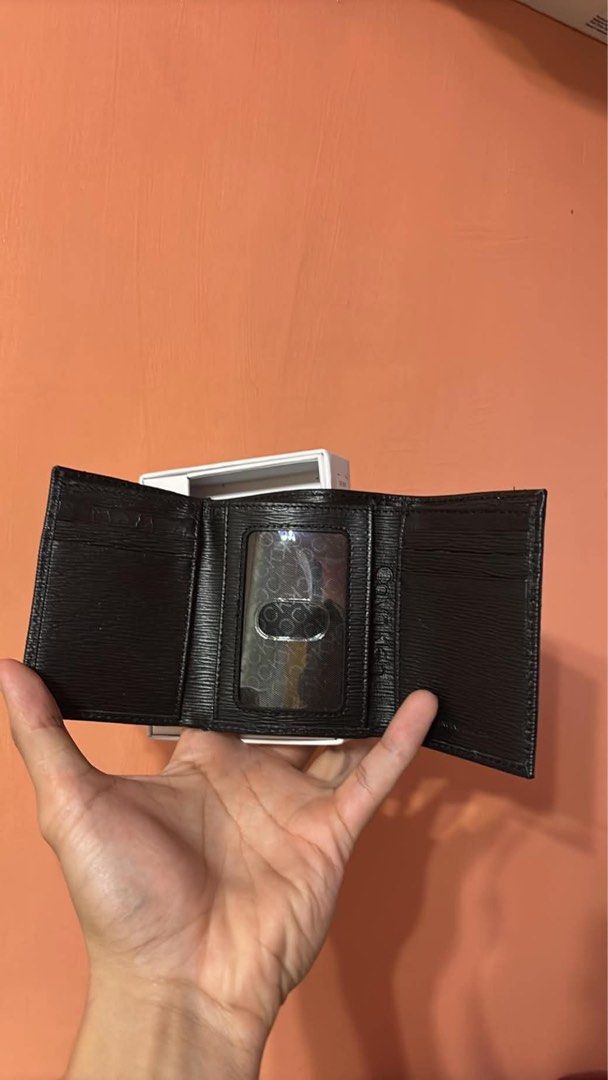 Calvin Klein Black Leather Trifold Wallet with Box (Category: Wallets & Card Holders) located in San Pablo. Submitted by whynotthriftph (Listing ID 1466304811, Image 2). Description: Black textured leather wallet from Calvin Klein. Trifold design with multiple card slots and a clear ID window. Gold CK logo hardware on the front. Includes original packaging box with RFID protection labeling. Clean inside and out, zero scratches or wear marks..