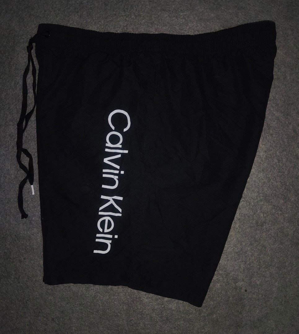 Calvin Klein Shorts Black Large (Category: Swim Trunks & Board Shorts) located in Cagayan de Oro. Submitted by adamfitz (Listing ID 1466166443, Image 2). Description: - Brand: Calvin Klein - Color: Black with white logo print down the left leg - Size: Large (L) - Material: 100% Repreve recycled polyester - Lining: Comfortable inner mesh lining - Features: Drawstring waistband with branded tips - Origin: Made in Vietnam - Condition: excellent cond