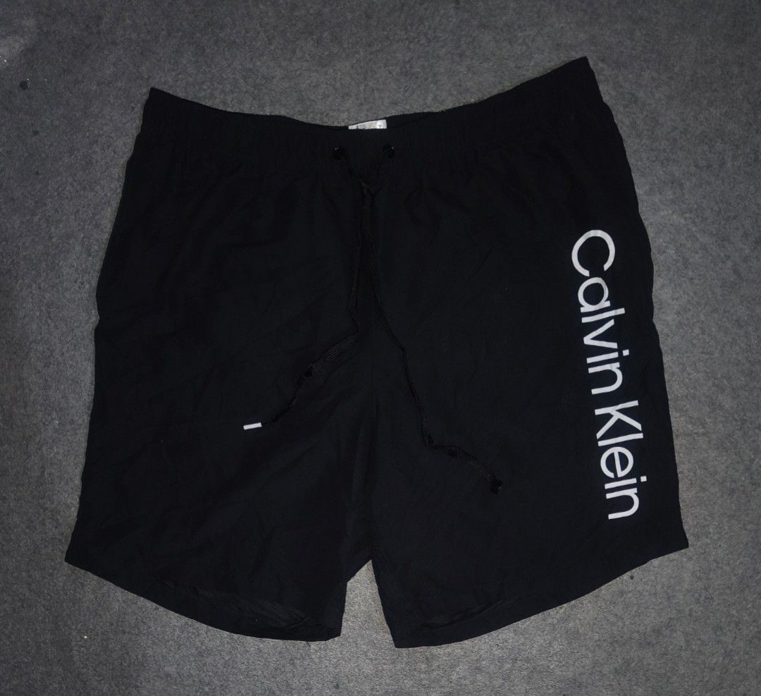 Calvin Klein Shorts Black Large (Category: Swim Trunks & Board Shorts) located in Cagayan de Oro. Submitted by adamfitz (Listing ID 1466166443, Image 1). Description: - Brand: Calvin Klein - Color: Black with white logo print down the left leg - Size: Large (L) - Material: 100% Repreve recycled polyester - Lining: Comfortable inner mesh lining - Features: Drawstring waistband with branded tips - Origin: Made in Vietnam - Condition: excellent cond