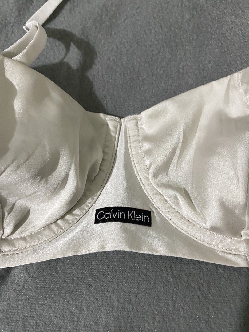 Calvin Klein White Bra Size 34B (Category: Undergarments & Loungewear) located in Maasin. Submitted by loveanatalia (Listing ID 1466251149, Image 2). Description: - Calvin Klein white bra, model QF8393. - condition 10/10; no stains, rips, etc. -Underwire support with smooth satin cups and mesh panels on the band. - Adjustable shoulder straps and back hook-and-eye closure. Size 34B US/UK, FR 90B. - Small Calvin Klein logo patch on the front center