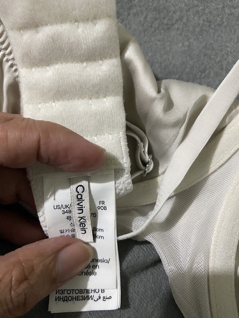 Calvin Klein White Bra Size 34B (Category: Undergarments & Loungewear) located in Maasin. Submitted by loveanatalia (Listing ID 1466251149, Image 3). Description: - Calvin Klein white bra, model QF8393. - condition 10/10; no stains, rips, etc. -Underwire support with smooth satin cups and mesh panels on the band. - Adjustable shoulder straps and back hook-and-eye closure. Size 34B US/UK, FR 90B. - Small Calvin Klein logo patch on the front center