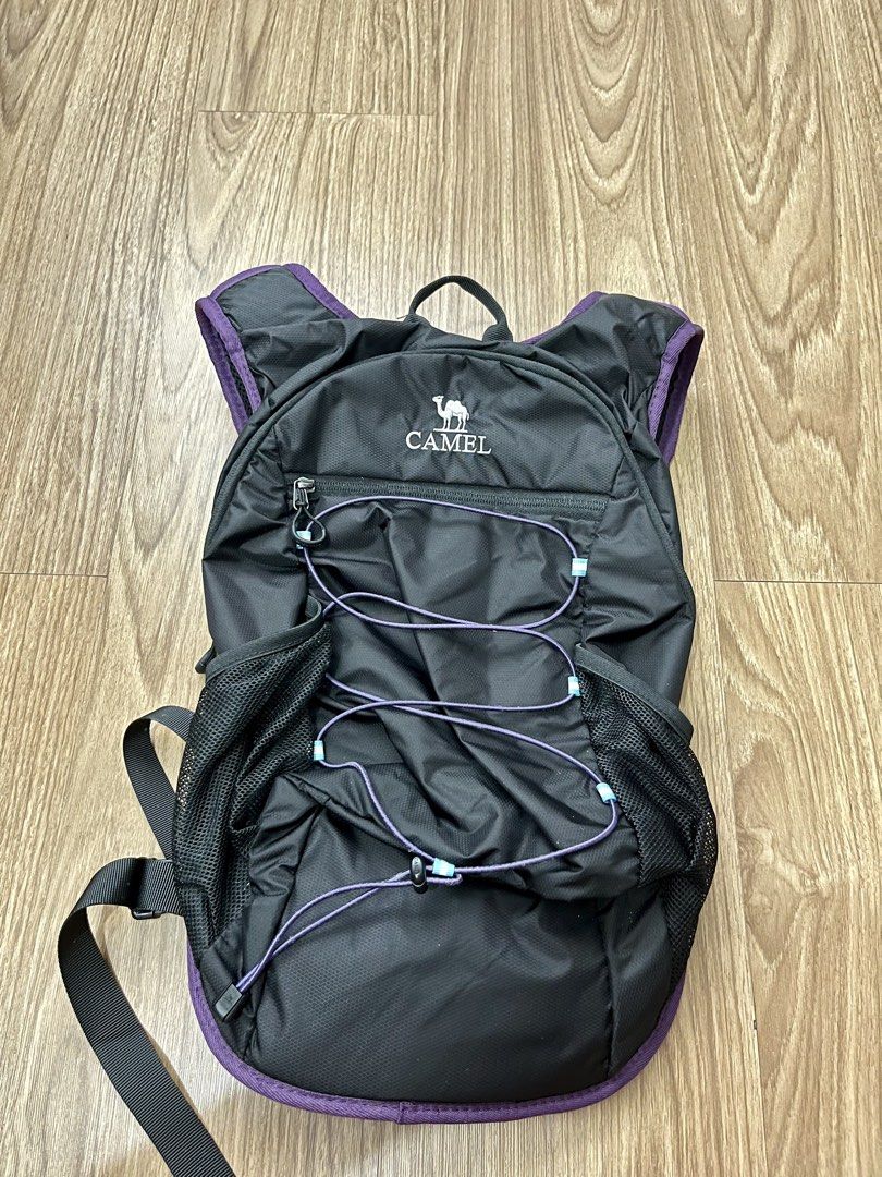 CAMEL CROWN 18L Hiking Backpack Black Purple (Category: Hiking & Camping) located in Makati City. Submitted by angel64119 (Listing ID 1466214945, Image 1). Description: Camel Crown 18L Hiking Backpack Original price: 1,072 php Never used RFS: Mas prefer mag light pack - Brand: CAMEL CROWN - Color: Black with stylish purple trim - Compact Dimensions: 45cm x 28cm x 14cm - Storage: Mesh side pockets and front bungee cord storage - Comfort: Padded sh