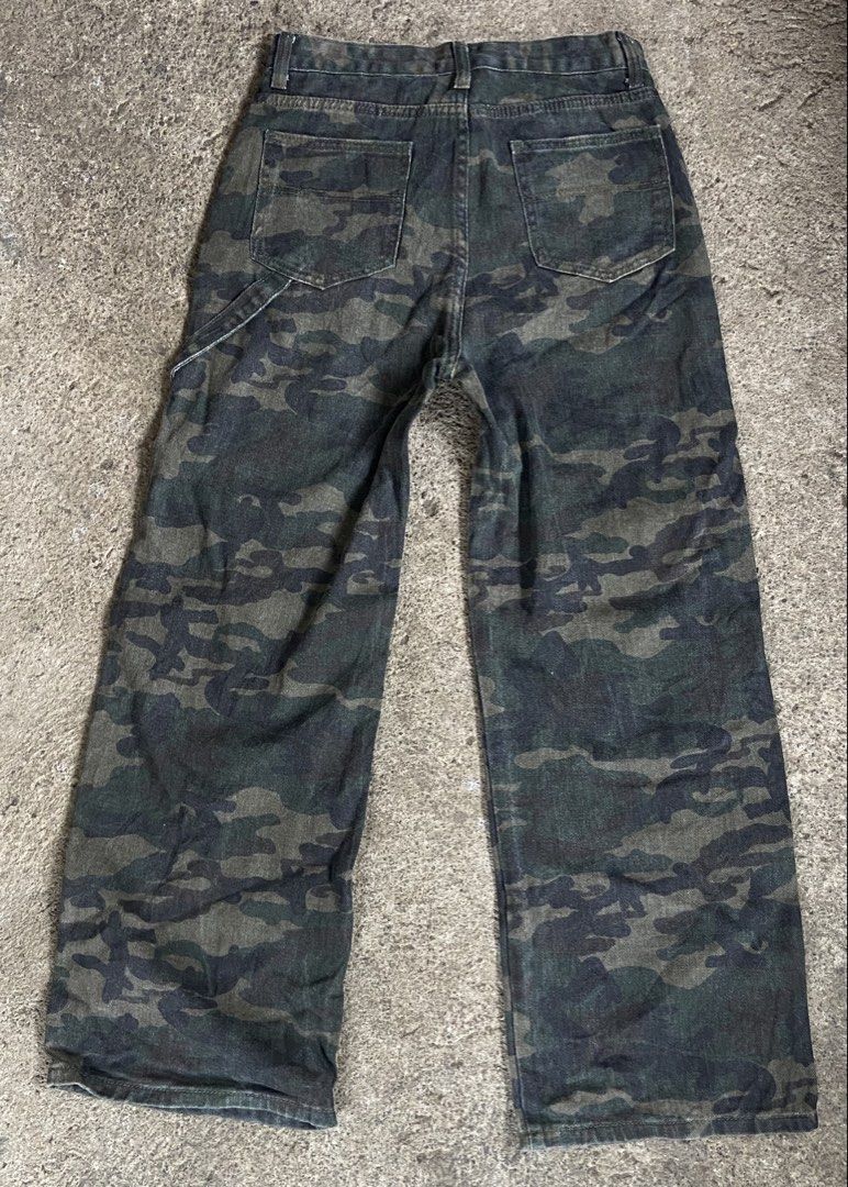 Camouflage Pants Carpenter Jeans (Category: Jeans) located in Polomolok. Submitted by tnecniv311 (Listing ID 1466276611, Image 2). Description: - Design: Classic green and black camo pattern - Style: Carpenter fit with straight legs - Features: Functional utility pockets and side hammer loop - Material: Durable heavy-duty cotton - Waist: Button closure with belt loops - Condition: Ready to wear.