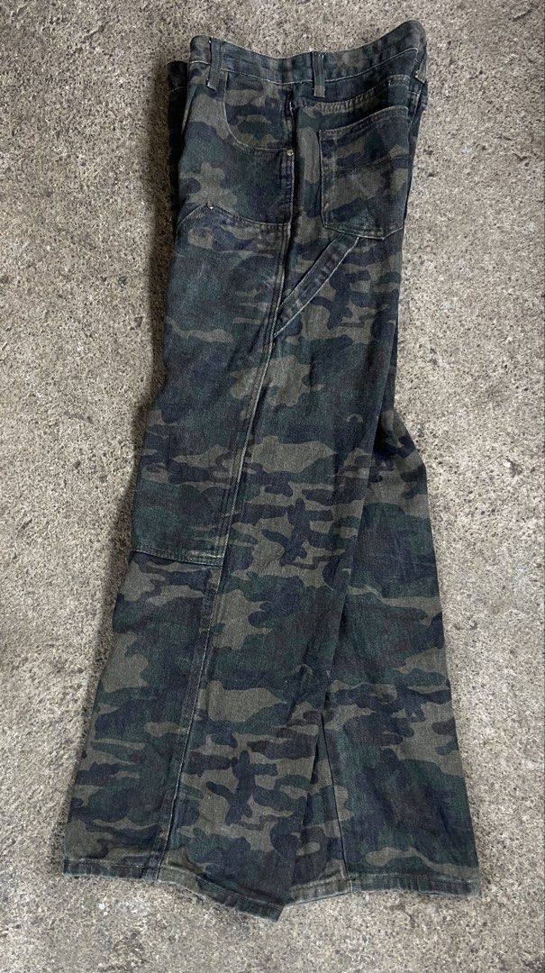 Camouflage Pants Carpenter Jeans (Category: Jeans) located in Polomolok. Submitted by tnecniv311 (Listing ID 1466276611, Image 3). Description: - Design: Classic green and black camo pattern - Style: Carpenter fit with straight legs - Features: Functional utility pockets and side hammer loop - Material: Durable heavy-duty cotton - Waist: Button closure with belt loops - Condition: Ready to wear.