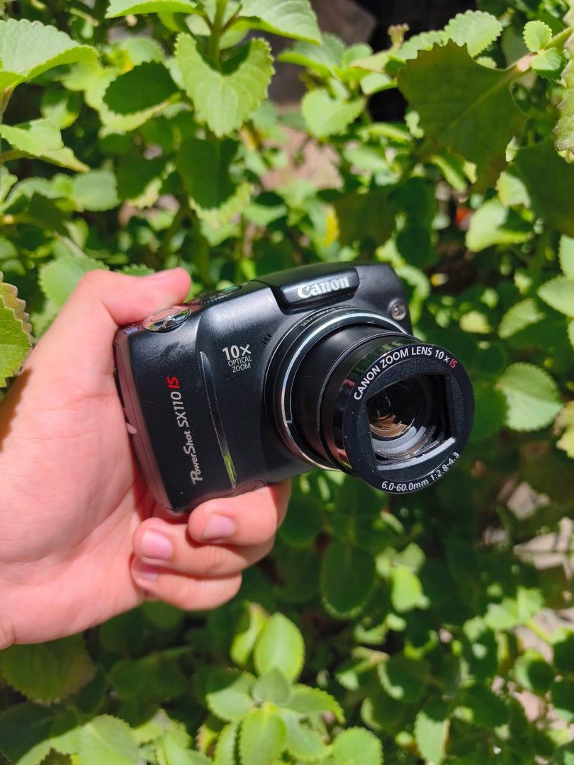 Canon PowerShot SX110 IS Digital Camera (Category: Cameras) located in Manila. Submitted by caliii1 (Listing ID 1466171884, Image 2). Description: - Model: Canon PowerShot SX110 IS (Black) - Resolution: 9.0 Megapixels - Zoom: 10x Optical Zoom Lens with Image Stabilizer - Usability: Convenient top mode dial for auto, manual, and scene settings - Power: Uses standard batteries (super easy to replace!) - Design: Compact and travel-friendly body with