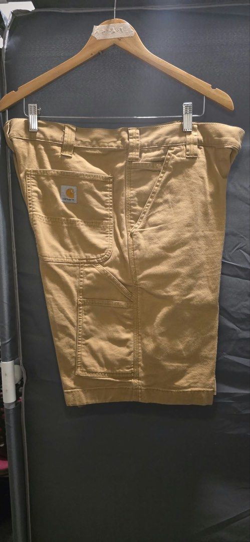 Carhartt Canvas Utility Work Shorts Tan (Category: Shorts) located in Makati City. Submitted by carlju (Listing ID 1466329384, Image 1). Description: - Brand: Carhartt - Style: Utility shorts / Canvas workwear - Color: Classic tan - Size: 36x20.5x11.5 - Features: Multiple side pockets for tools and gear, heavy-duty stitching, standard button and zipper fly - Condition: Clean and ready to wear.