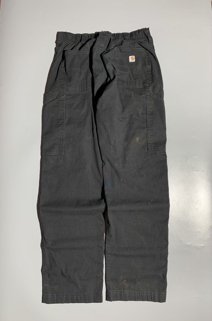 Carhartt Ripstop Cargo Straight Loose Pants (Category: Jeans) located in Bulacan. Submitted by aaron_garrucho15 (Listing ID 1466327872, Image 1). Description: Dimes: 32 waistline x 38 length - Color: Dark grey - Material: Durable ripstop fabric - Fit: Comfortable elastic waistband - Storage: Utility pockets on both legs - Details: Signature Carhartt logo patch on back right pocket - Condition: Stains present near the lower legs and upper thigh ar