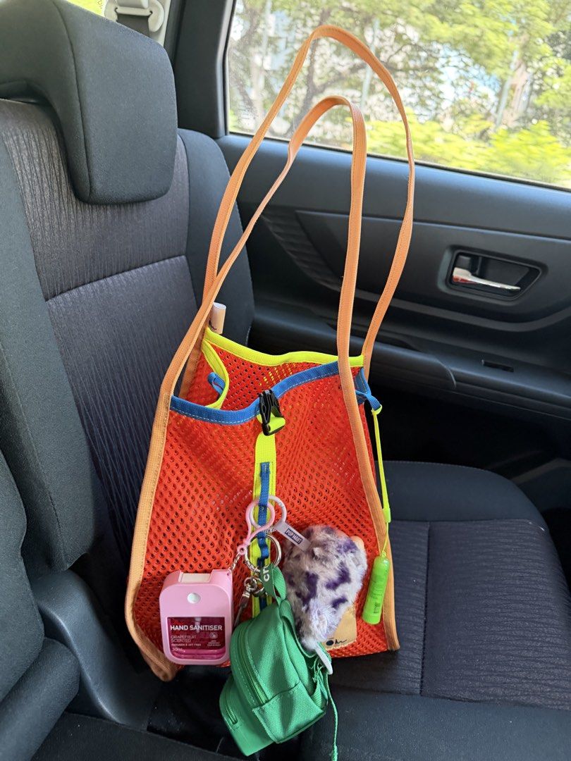 Carryom mala medium (Category: Tote Bags) located in Makati City. Submitted by beymadrigal (Listing ID 1465947036, Image 1). Description: - Color: Bright orange mesh with blue and yellow trim - Straps: Long orange straps designed for comfortable shoulder wear - Features: Center front buckle accent and a cute small pink charm near the bottom - Convenience: Lightweight fabric, ideal for easy, all-day carrying.