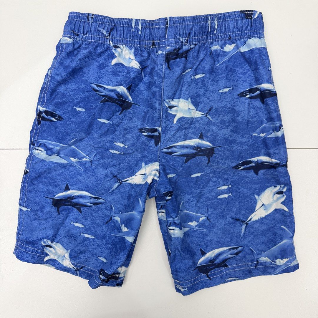 Carter's Shark Swim Trunks Size 7 (Category: Babies & Kids Fashion) located in Pasig City. Submitted by boymom20 (Listing ID 1466199672, Image 2). Description: - Brand: Carter's - Item: Boy's Swim Trunks - Size: 7 (Tag attached) - Design: Fun all-over shark print in blue - Comfort: Elastic waistband with adjustable drawstring - Interior: Built-in mesh lining - Condition: Great for pool, beach, or vacation LAST PRICE POSTED + 75 SHIPPING FEE VIA J