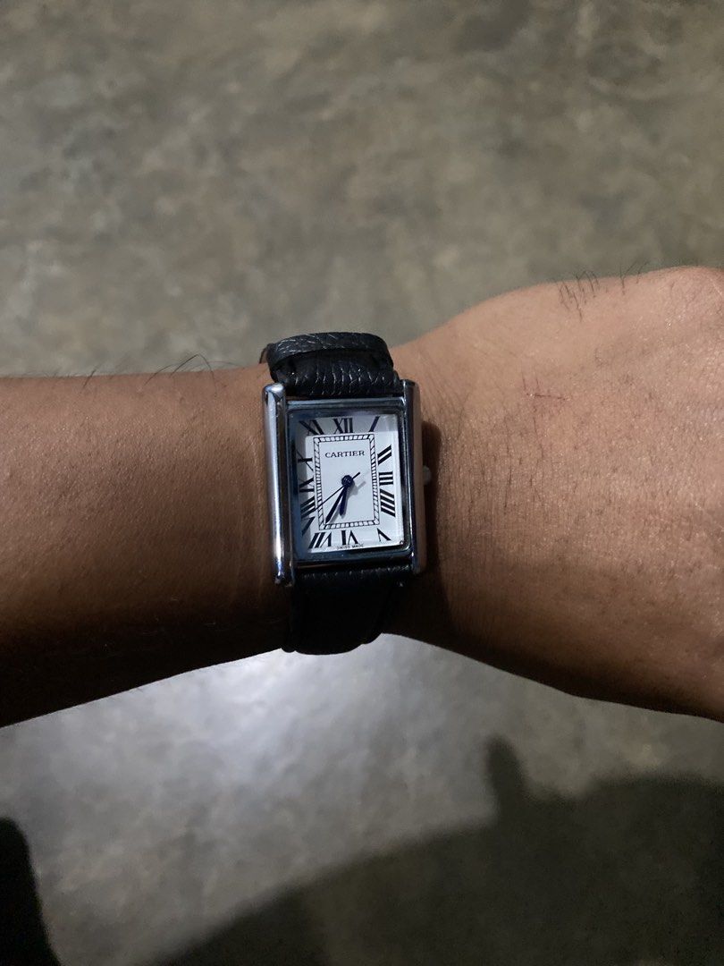 Cartier Tank Watch Black Leather Strap (Category: Luxury Watches) located in Abulug. Submitted by axeldot (Listing ID 1466249463, Image 3). Description: Cartier Tank rectangular wristwatch. Silver-tone case with white dial and Roman numerals. Blue sword hands. Black textured leather strap with beige backing. Classic dress watch style suitable for daily wear or formal occasions..