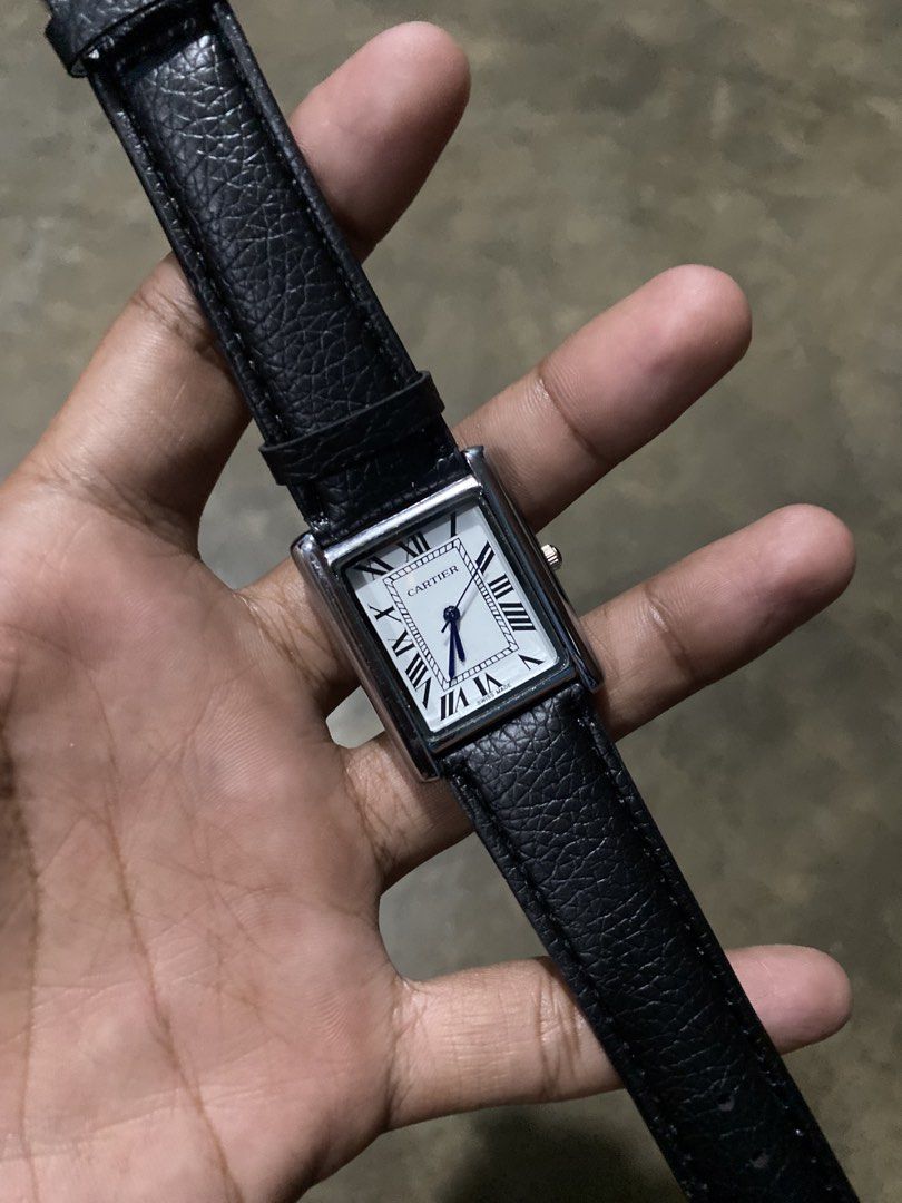 Cartier Tank Watch Black Leather Strap (Category: Luxury Watches) located in Abulug. Submitted by axeldot (Listing ID 1466249463, Image 1). Description: Cartier Tank rectangular wristwatch. Silver-tone case with white dial and Roman numerals. Blue sword hands. Black textured leather strap with beige backing. Classic dress watch style suitable for daily wear or formal occasions..