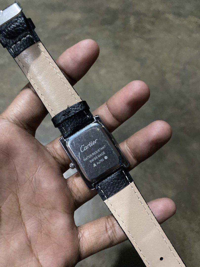 Cartier Tank Watch Black Leather Strap (Category: Luxury Watches) located in Abulug. Submitted by axeldot (Listing ID 1466249463, Image 2). Description: Cartier Tank rectangular wristwatch. Silver-tone case with white dial and Roman numerals. Blue sword hands. Black textured leather strap with beige backing. Classic dress watch style suitable for daily wear or formal occasions..