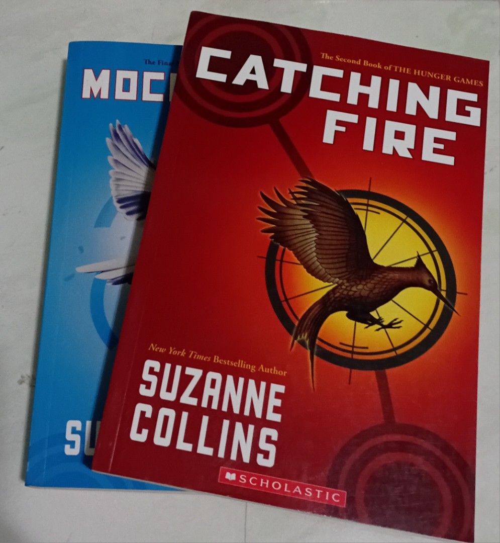 Catching Fire and Mockingjay The Hunger Games (Category: Storybooks) located in Manila. Submitted by luckyfox-3a3e (Listing ID 1466311414, Image 1). Description: - Includes 2 books: Catching Fire (Book 2) and Mockingjay (Book 3) - Author: Suzanne Collins - Publisher: Scholastic (Asia edition) - Genre: Dystopian fiction / Young Adult - Format: Paperback set (Red and Blue covers).