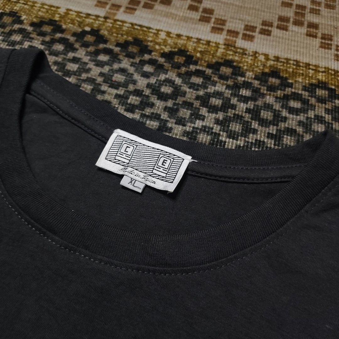 Cav Empt Dark Grey T-shirt (Category: Tshirts & Polo Shirts ) located in Taguig. Submitted by althriftdailyloots94 (Listing ID 1466267674, Image 3). Description: Cav Empt t-shirt in dark grey. Short sleeves, round neck. Rubber C.E logo patch on the left sleeve in red and white. White brand tag stitched at the inside collar. Made in Japan tag attached below collar. Size XL label underneath. Clean stitching throughout..