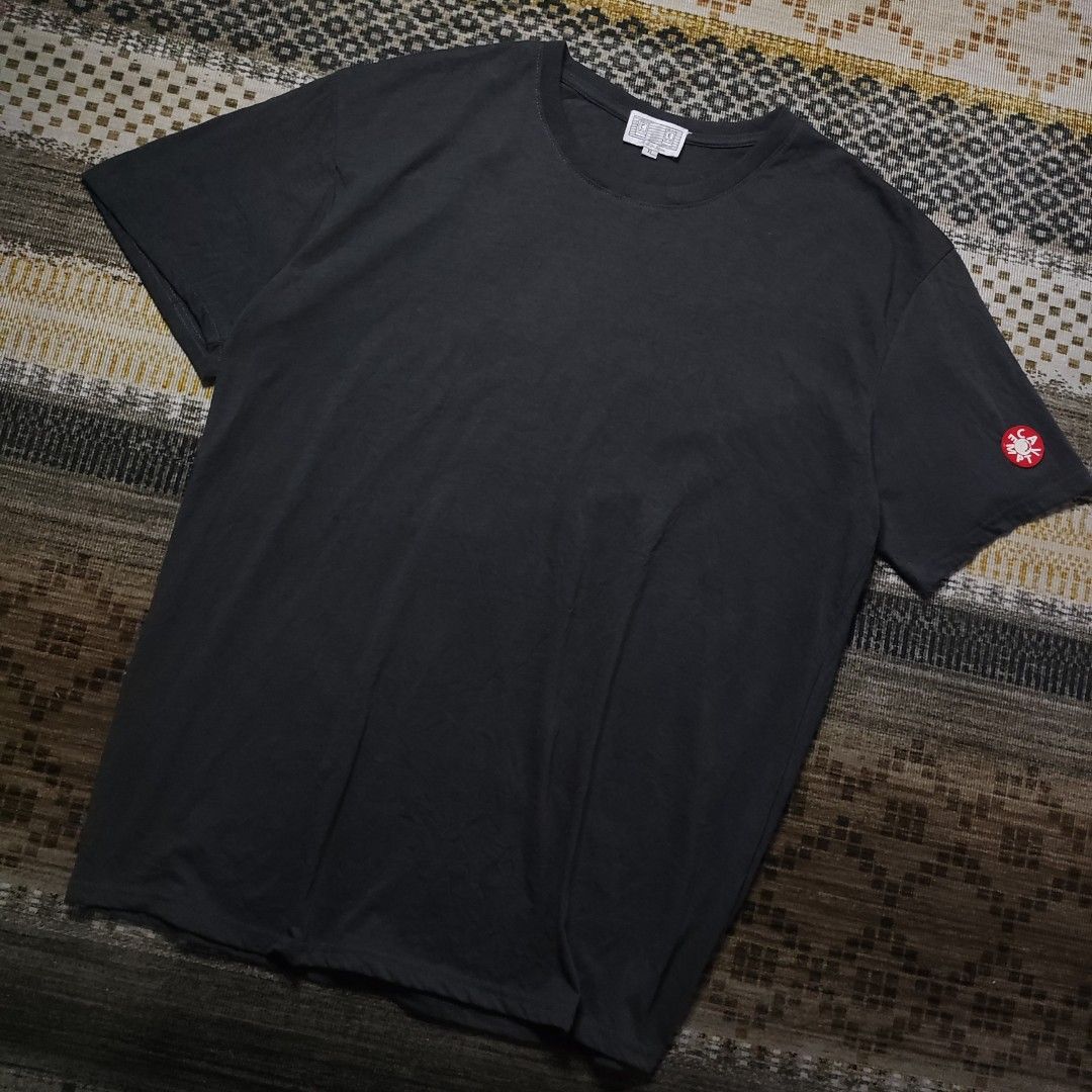 Cav Empt Dark Grey T-shirt (Category: Tshirts & Polo Shirts ) located in Taguig. Submitted by althriftdailyloots94 (Listing ID 1466267674, Image 2). Description: Cav Empt t-shirt in dark grey. Short sleeves, round neck. Rubber C.E logo patch on the left sleeve in red and white. White brand tag stitched at the inside collar. Made in Japan tag attached below collar. Size XL label underneath. Clean stitching throughout..