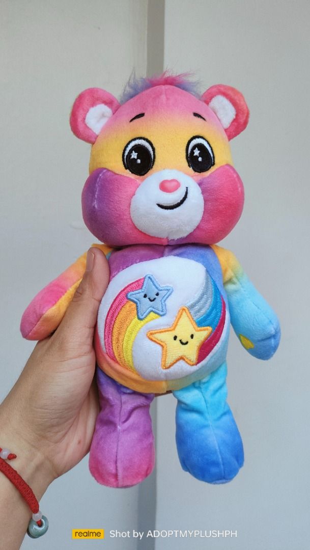 CARE BEARS Dare to Care Bear Basic Fun Size Plush Toy (Category: Plushies & Soft Toys) located in Taguig. Submitted by adopt.my.plush.ph (Listing ID 1466242599, Image 3). Description: Dare to Care Bear bean plush toy from the Care Bears collection by Basic Fun. Key Features • Character: Dare to Care Bear, a friendly bear that champions kindness and acceptance. • Design: Multi-colored pastel tie-dye fur with pink, yellow, blue, and purple tones. •