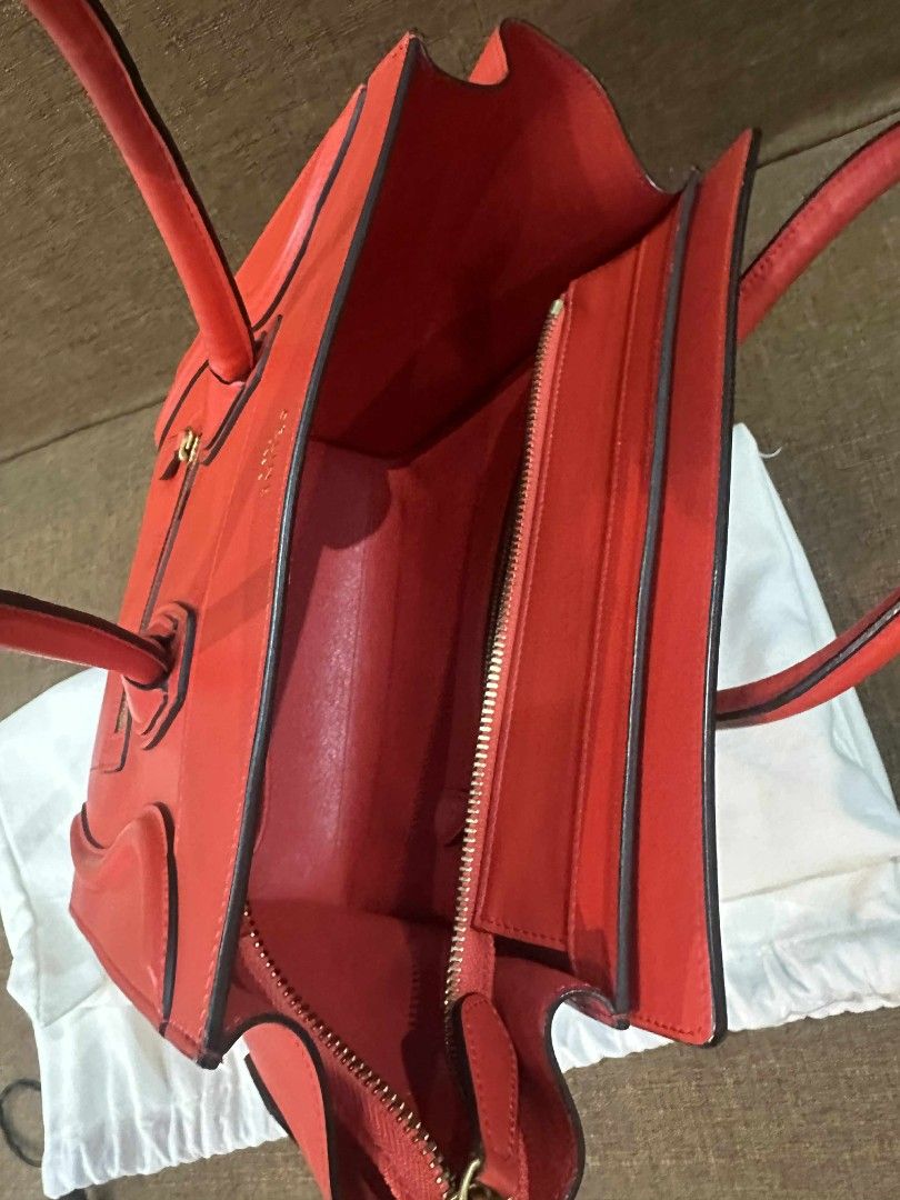 Celine Micro Luggage (Category: Luxury Bags & Wallets) located in Quezon City. Submitted by paulyn02 (Listing ID 1466251259, Image 2). Description: Bright red Celine micro luggage tote. Structured leather body with rolled handles and a front zip pocket. Gold hardware stamped with Celine Paris. Interior lined in matching red leather with an inner zip pocket and slip compartments. Original dust bag included. Clean interior and crisp edges throughou