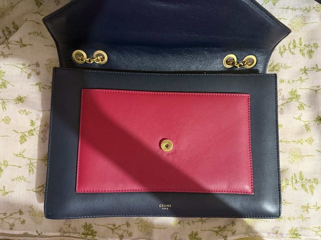 Celine Tri-Color Envelope Chain Shoulder Bag (Category: Luxury Bags & Wallets) located in Dagupan City. Submitted by anacoded (Listing ID 1466317545, Image 3). Description: - Brand: Celine - Style: Tri-color leather shoulder bag - Colors: Navy blue body, grey flap, and vibrant pink front pocket - Hardware: Gold-tone chain strap and hardware - Closure: Snap button closure. Interior zipper pocket with Celine branding and Made in Italy stamp - Condi