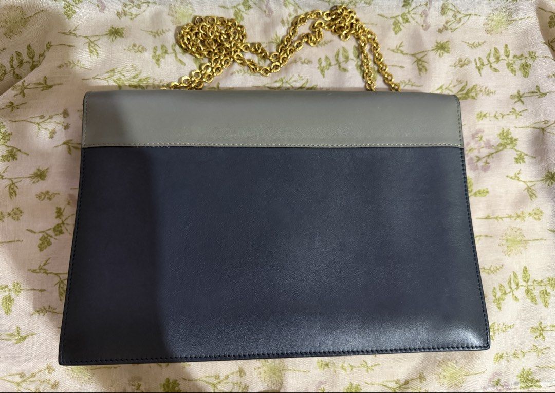 Celine Tri-Color Envelope Chain Shoulder Bag (Category: Luxury Bags & Wallets) located in Dagupan City. Submitted by anacoded (Listing ID 1466317545, Image 2). Description: - Brand: Celine - Style: Tri-color leather shoulder bag - Colors: Navy blue body, grey flap, and vibrant pink front pocket - Hardware: Gold-tone chain strap and hardware - Closure: Snap button closure. Interior zipper pocket with Celine branding and Made in Italy stamp - Condi