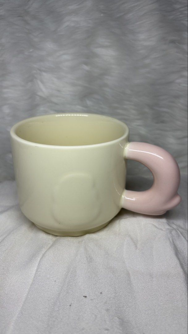 Ceramic Mug with Pink Handle (Category: Coffee & Tea Tableware) located in Manila. Submitted by mug.aras (Listing ID 1466313914, Image 1). Description: Super cute ceramic mug in soft cream with a chunky pink handle and embossed character silhouette. Perfect for your daily coffee or tea. Clean and ready to use!.