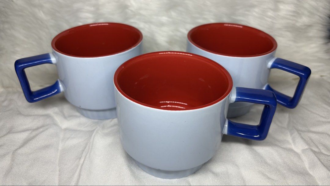 Ceramic Mugs Light Blue and Red Interior (Category: Coffee & Tea Tableware) located in Manila. Submitted by mug.aras (Listing ID 1466315725, Image 1). Description: Modern ceramic mugs with light blue exterior, striking red interior, and unique angular blue handles. Space-saving design in flawless condition with no chips or cracks. Perfect for your kitchen or coffee bar. (₱200 each - 2 pcs available).