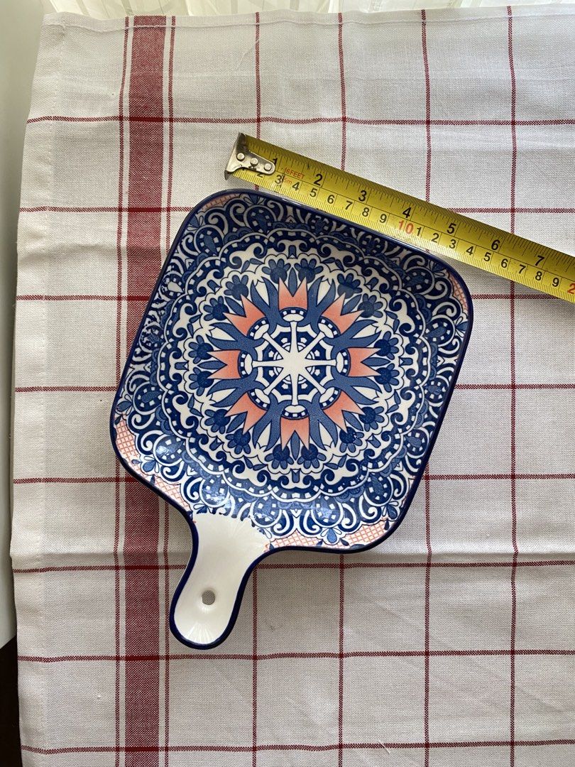 Ceramic serving dish with handle blue mandala pattern (Category: Dinnerware & Cutlery) located in Mandaluyong City. Submitted by lovegood711 (Listing ID 1466160269, Image 2). Description: Square, ceramic serving dish with beautiful blue and peach mandala pattern. Handy handle with hole for hanging or easy grip. Measures around 8 inches across. Deep edges to keep food contained. Great for serving snacks, side dishes, your morning sandwich, appetiz